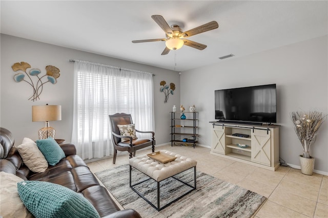 living room featuring light tile patterned floors and ceiling fan