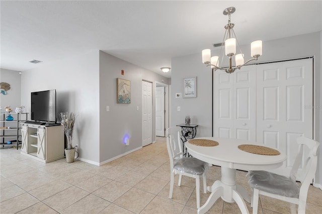 dining room with light tile patterned floors and a chandelier