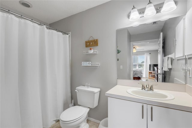 bathroom featuring ceiling fan, vanity, toilet, and a textured ceiling