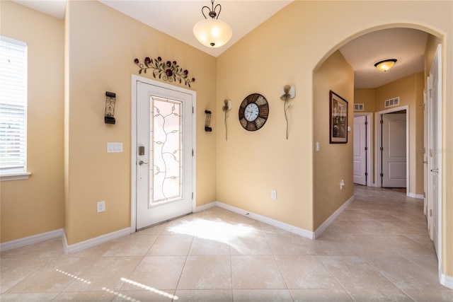 tiled foyer entrance with a healthy amount of sunlight