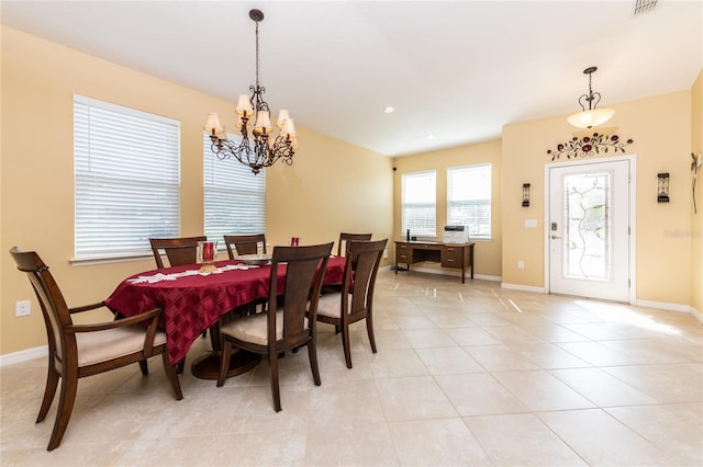 tiled dining space with a chandelier