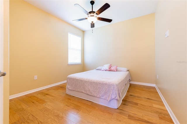 bedroom with ceiling fan and light hardwood / wood-style flooring