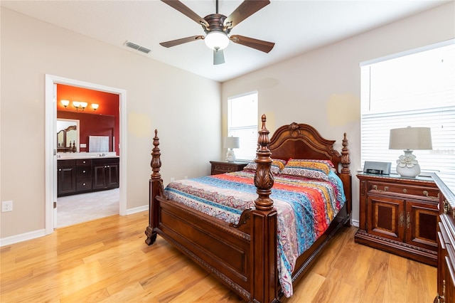 bedroom with ensuite bath, ceiling fan, and light hardwood / wood-style floors