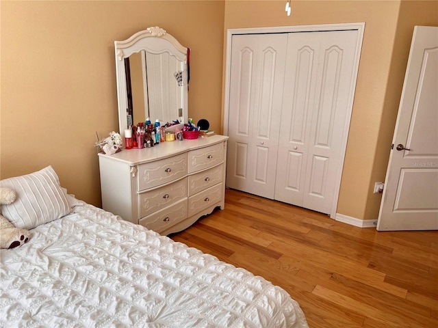 bedroom with a closet and light hardwood / wood-style floors