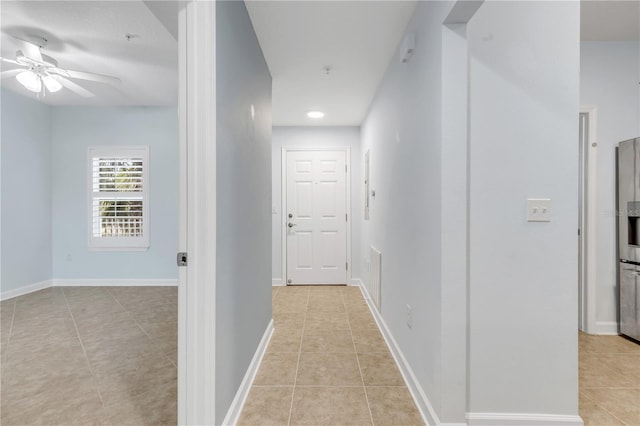 corridor featuring light tile patterned flooring