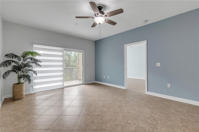 spare room with ceiling fan and light tile patterned floors