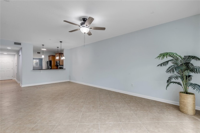 unfurnished living room featuring light tile patterned flooring and ceiling fan with notable chandelier