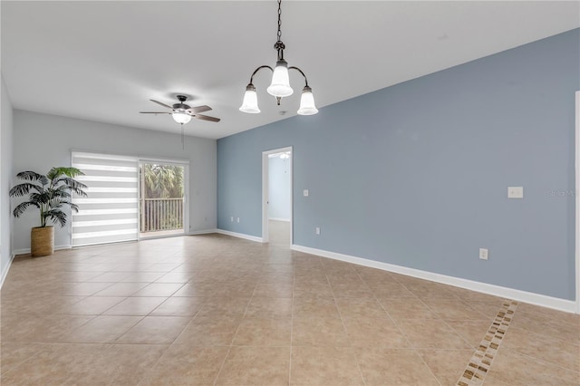 empty room with ceiling fan with notable chandelier and light tile patterned floors