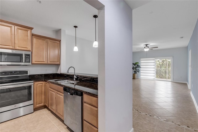 kitchen featuring light tile patterned flooring, appliances with stainless steel finishes, hanging light fixtures, and sink