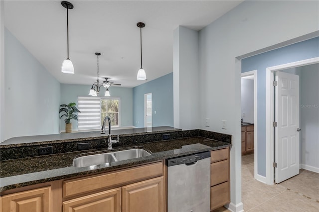 kitchen featuring pendant lighting, light tile patterned flooring, sink, dishwasher, and dark stone counters