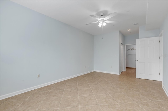 empty room with light tile patterned floors and ceiling fan