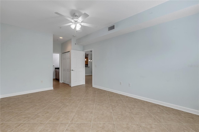 tiled spare room featuring ceiling fan