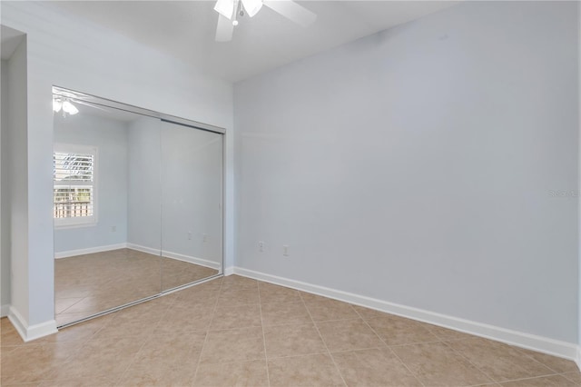 unfurnished bedroom with ceiling fan, a closet, and light tile patterned floors