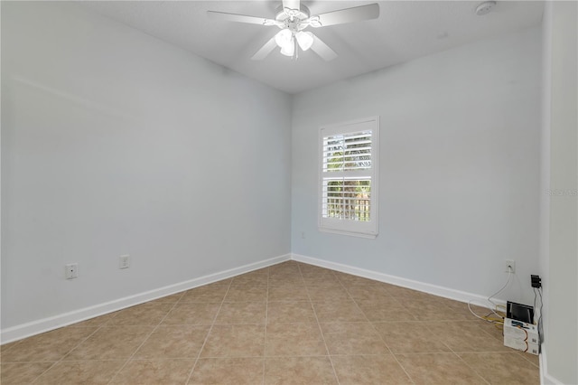 tiled spare room featuring ceiling fan