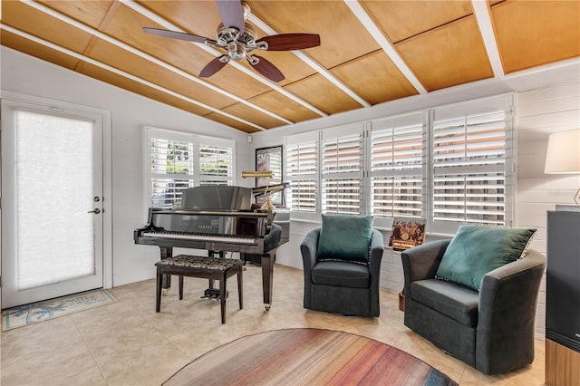 living area with lofted ceiling, light tile patterned floors, wood ceiling, and ceiling fan