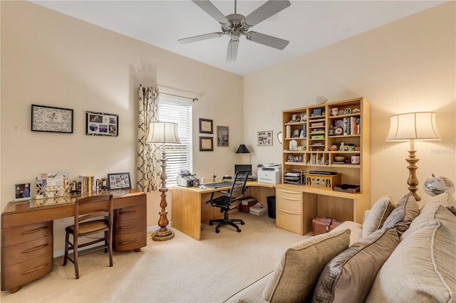 carpeted office space featuring ceiling fan