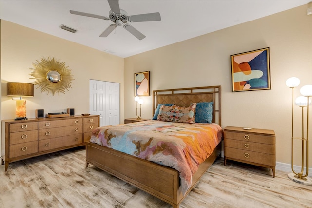 bedroom with light hardwood / wood-style flooring, a closet, and ceiling fan