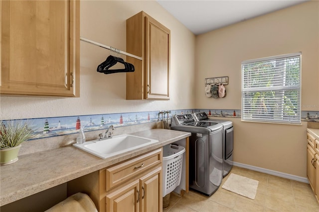 washroom with light tile patterned floors, cabinets, sink, and washer and clothes dryer