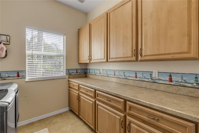 kitchen with light brown cabinets, washing machine and clothes dryer, and light tile patterned floors