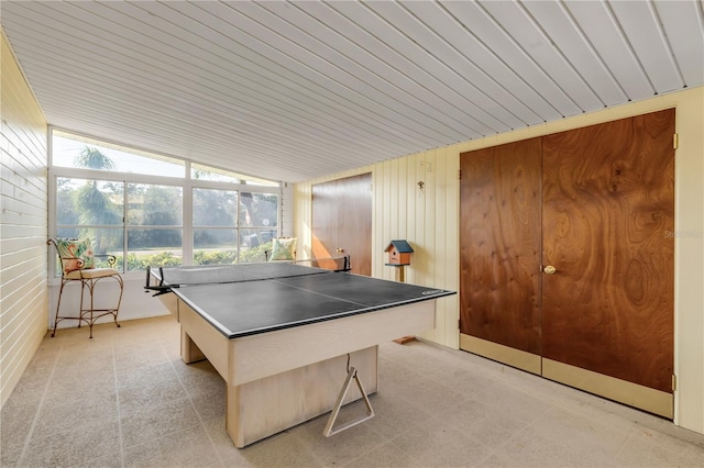 recreation room with lofted ceiling, wooden walls, and wooden ceiling