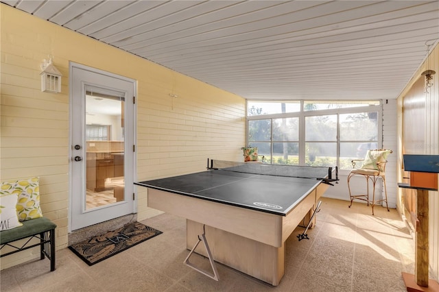 rec room with wood ceiling, brick wall, and vaulted ceiling