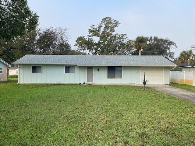 single story home with a garage and a front lawn