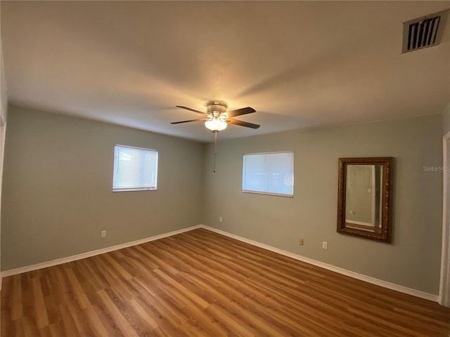 spare room featuring hardwood / wood-style flooring and ceiling fan