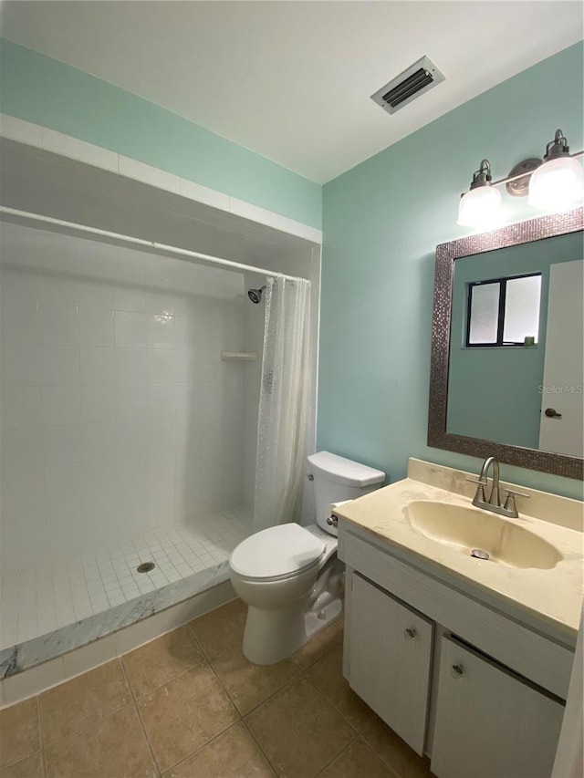 bathroom featuring vanity, tile patterned flooring, toilet, and curtained shower