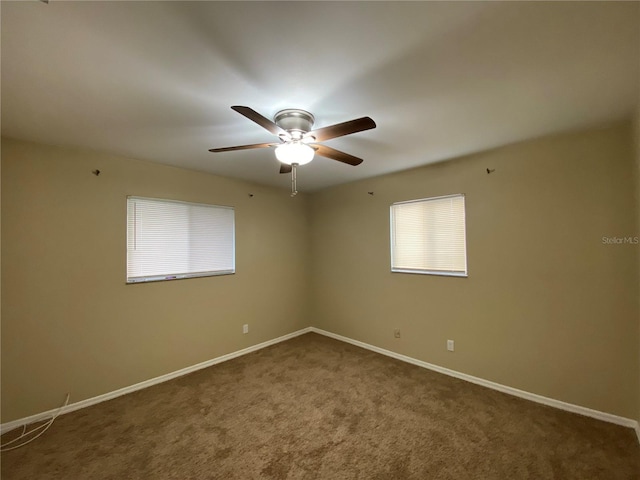 carpeted empty room featuring ceiling fan