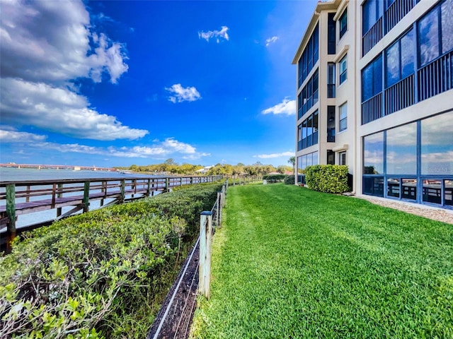 exterior space with a water view and a lawn