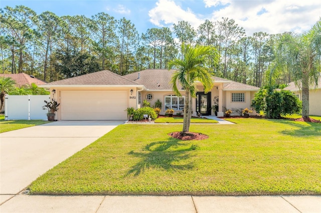 ranch-style home featuring a garage, driveway, a gate, stucco siding, and a front lawn