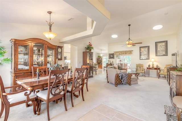 dining space featuring light colored carpet and ceiling fan