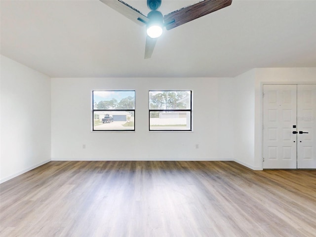 unfurnished room featuring light wood-type flooring and ceiling fan