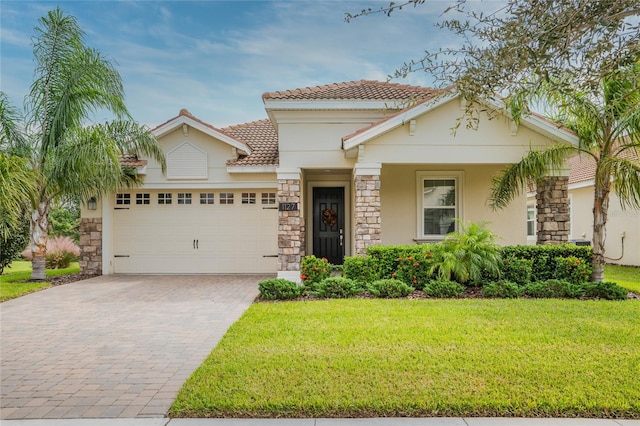 mediterranean / spanish house featuring a front lawn and a garage