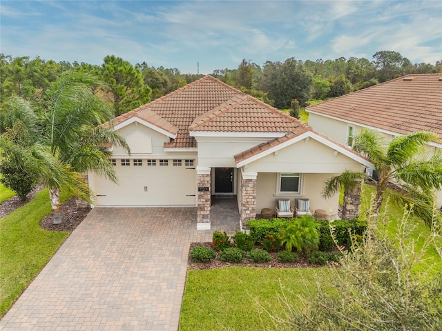 mediterranean / spanish-style home with a front lawn, central AC, and a garage