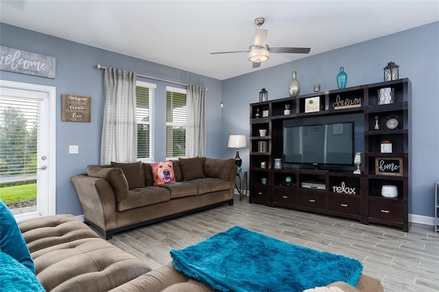 living room featuring ceiling fan and light hardwood / wood-style flooring