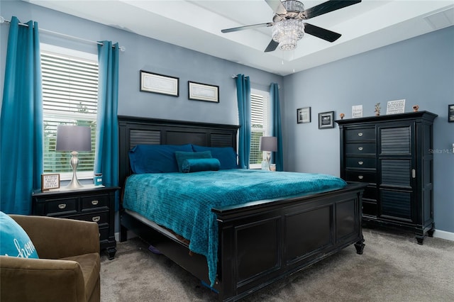 bedroom with multiple windows, carpet floors, and ceiling fan