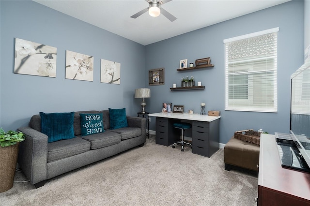 carpeted office featuring ceiling fan