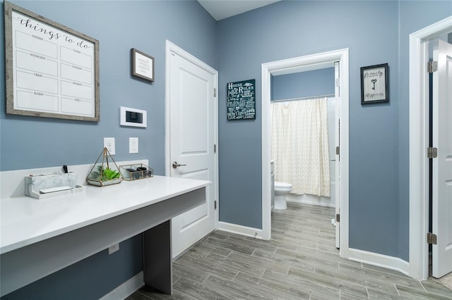 bathroom featuring toilet, hardwood / wood-style flooring, and vanity