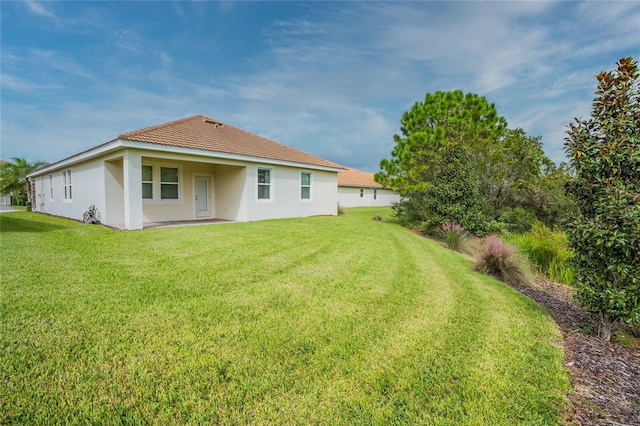 back of house with a yard