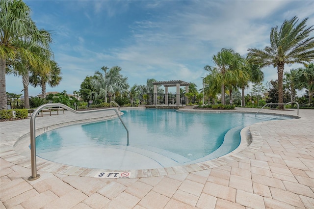 view of swimming pool with a patio area and a pergola