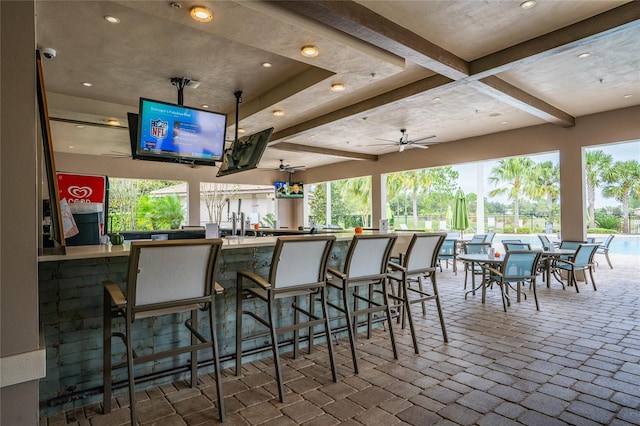 bar with beamed ceiling and ceiling fan