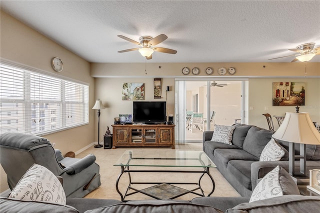 living room with ceiling fan and a textured ceiling