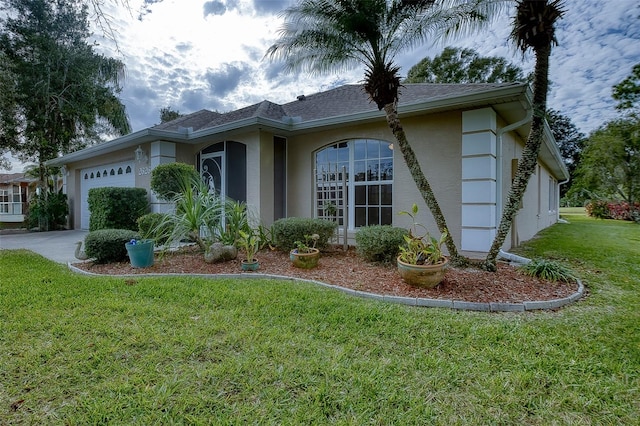 view of side of property with a yard and a garage