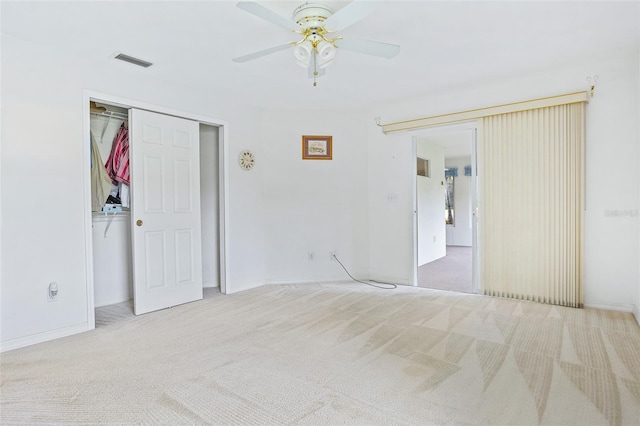 unfurnished bedroom featuring a closet, ceiling fan, and light colored carpet