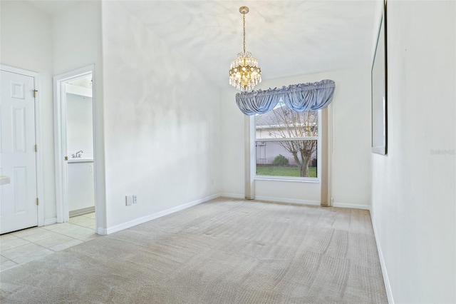 unfurnished room featuring a notable chandelier and light colored carpet