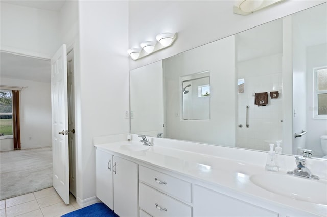 bathroom with vanity, tile patterned flooring, toilet, and a shower with door