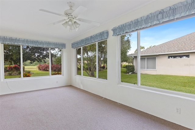 unfurnished sunroom with a wealth of natural light and ceiling fan