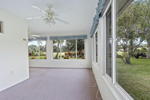 unfurnished sunroom featuring ceiling fan