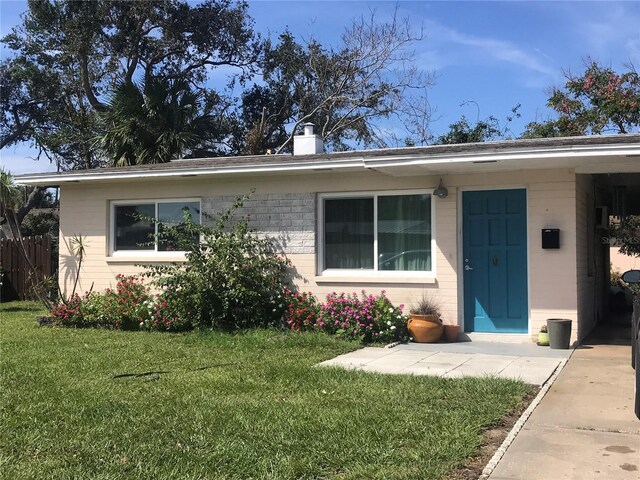 113 Neptune Dr, Edgewater, FL 32132 - view of front of house featuring a chimney, brick siding, and a front yard